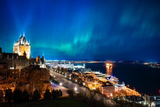 Wonderful Old Quebec city skyline and its street lights under a night sky of aurora borealis, Quebec, Canada