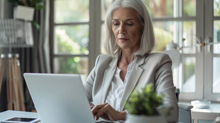 Fototapeta premium Professional Senior Businesswoman Working on Laptop at Home Office