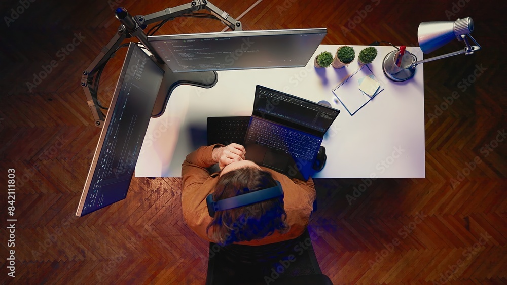 Poster top down view of developer typing complex code in home office, listening music and developing softwa