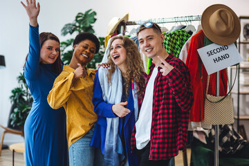 Students, young attractive people shopping in secondhand store, trying vintage clothes, bargain hunting. Sustainable lifestyle of generation z, eco friendly conscious consumerism, consignment stores