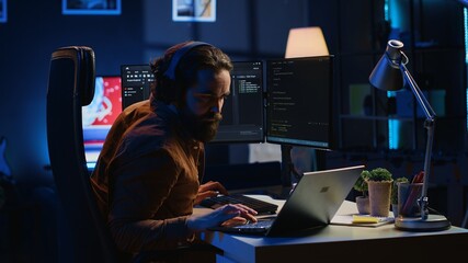 Fatigued developer working overnight at home, rubbing eyes while taking break from coding, feeling...