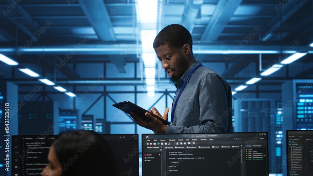 Poster engineer inputting data on tablet in server hub, monitoring data center energy consumption across ha