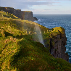 Waterfall blown upward on the windy coast of Ireland, near the Cliffs of Moher on Burren Way.
