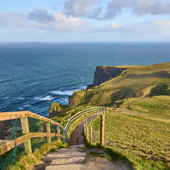 Looking down the Burren Way trail through the tall Cliffs of Moher in Ireland