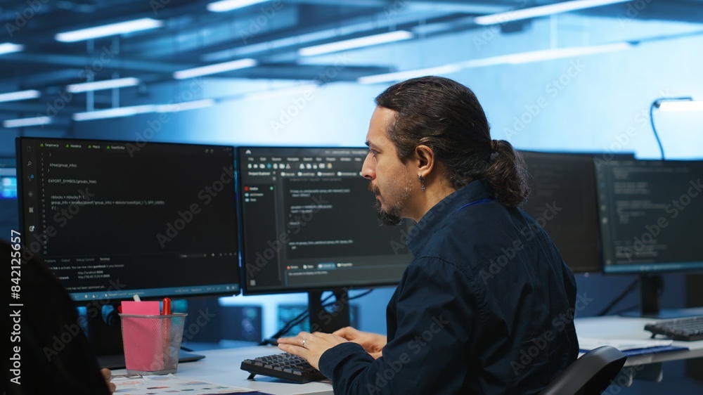 Poster knowledgeable engineer upgrading equipment in data center, zoom in shot. specialist at pc desk in hi