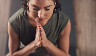 Woman, praying and hands for yoga meditation, wellness and calm exercise for top view or health club balance. Pilates, holistic and spiritual aura or body healing, zen and peace with yogi on floor