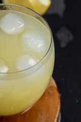 a close-up of lemons and a glass of lemon natural juice