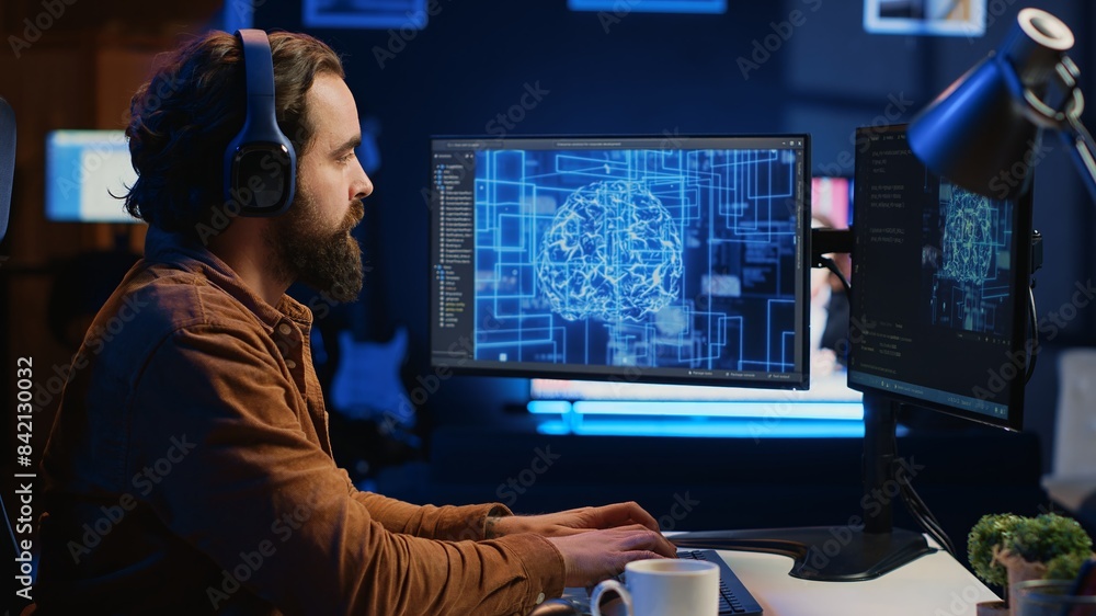 Poster developer updating artificial intelligence neural networks, drinking coffee and listening music in p