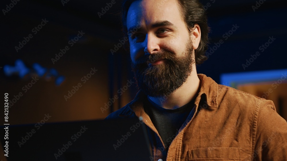 Aufkleber happy man doing it support job from home, standing in personal office with laptop in hand, coding, c