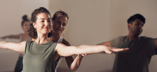 Fototapeta premium Woman, warrior pose and coach in yoga class, balance and exercise together for peace in studio. Female person, pilates and training a group of people, stretching and yogi for wellness in position