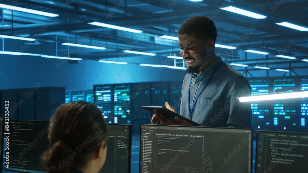 Poster it expert in server hub ensuring valuable data remains shielded from potential threats using tablet.
