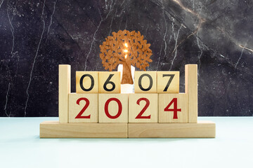 July 6 calendar date text on wooden blocks with blurred background park.