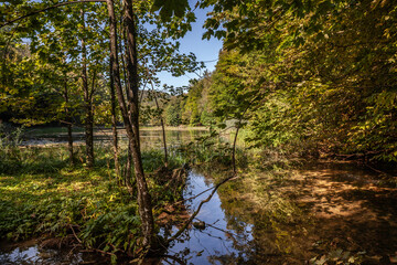 Panorama of the pond Jankovac, a small water lake surrounded by trees and forest in the Papuk mountain, a major national park of Croatia, in the Slavonia region.
