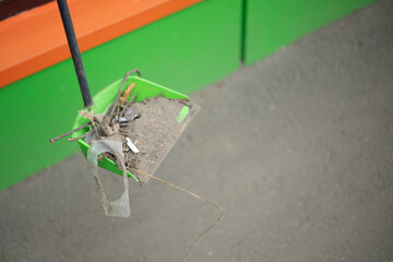 Cleaning up trash on the street. Scoop with fire. Broom for sweeping.