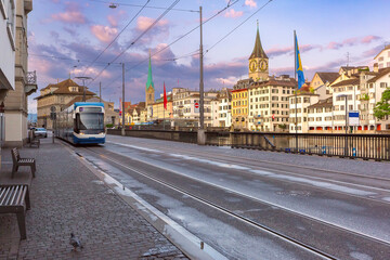 Zurich cityscape with tram on Munsterbrucke Bridge with Fraumunster and St Peters Church, Zurich,...