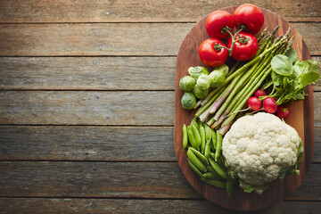 Above, desk and vegetable on wood board for cooking with diet, nutrition and healthy soup. Fresh,...