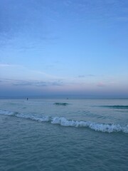 Distant paddleboarder with sunset sky over Gulf of Mexico Emerald Coast Florida 