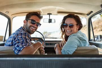 Portrait, couple and driving in car for vacation, road trip and destination location with smile....