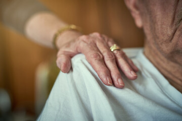 Elderly man, shoulder and hands in support of husband for wellness, empathy and person with...