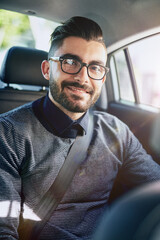 Portrait, man and driving in car for travel with morning commute, glasses and journey to business office. Happy passenger, male person and driver in auto transport for traveling to work and eyewear