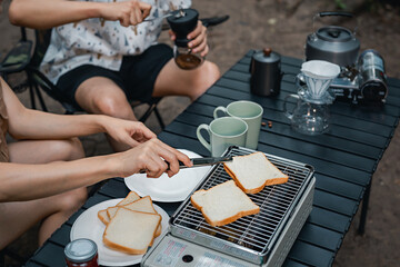 Close up of young couple camping, cooking together and dripping coffee in morning near the tent