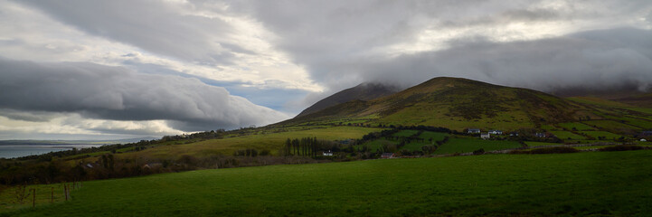 Caherconree in early morning light surrounded by clouds, Ireland