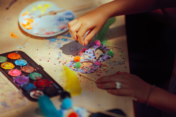 Child Spreading Glitter on a Carnival Mask in Art Class. Kid interested in arts and crafts as a...