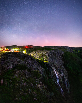 Mizarela village and waterfall under night sky
