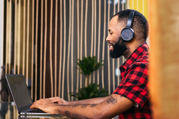 African american man teleworking with laptop from home
