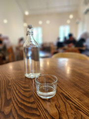 Drinking fresh water from the bottle in the coffee shop. Healthy lifestyle.