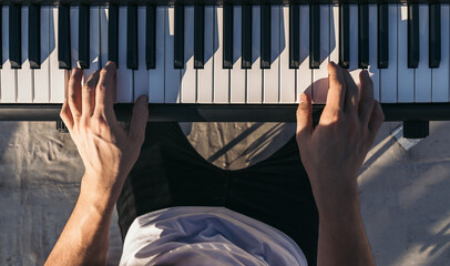man playing piano on an urban rooftop. top view
