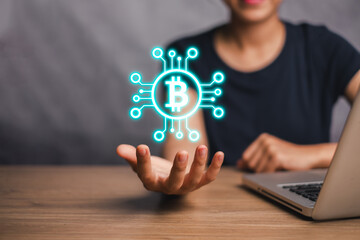 Bitcoin concept, Woman hand holding bitcoin on virtual screen, Bitcoin Cryptocurrency Digital Bit Coin BTC Currency Technology Business Internet Concept.