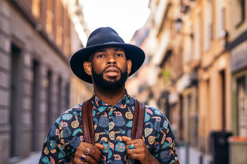 Stylish black man walking on the city street