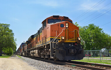 Diesel locomotive pulling a freight train of container cars