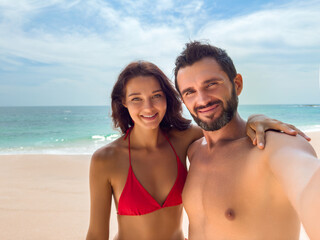 Fototapeta premium Smiling Couple Taking Selfie on Sunny Beach Vacation