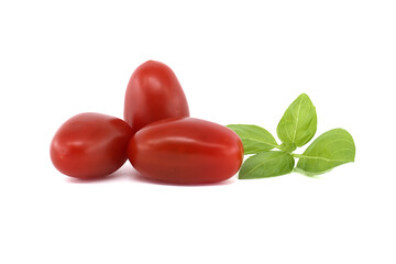 Fresh Roma tomatoes and basil leaves isolated on a white background