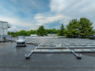 Photo of framing and concrete block ballast blocks for new solar panels being installed on a flat...