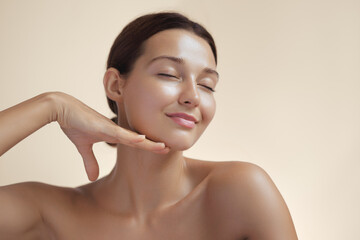 Photo of Natural Beauty Woman with Radiant Skin Touching By Hand