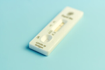 test for coronavirus, covid-19 on blue background. New, positive and negative rapid test cassette. Coronavirus test.