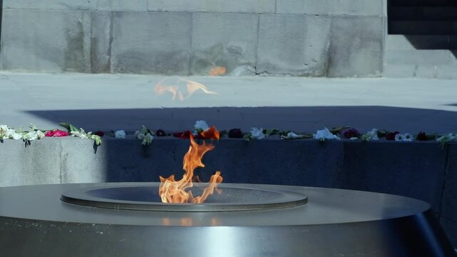 Close up eternal flame burns at Tsitsernakaberd memorial in Armenia