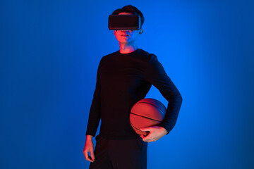 Asian athlete with VR holding a basketball player exploring virtual space on neon portrait sports...