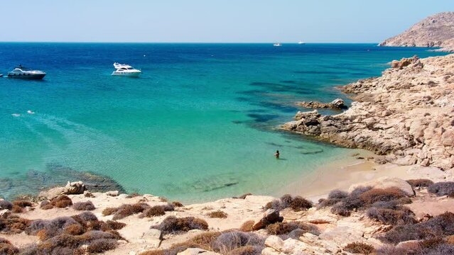 Mykonos, Greece, Elia Beach. Pristine bay with blue sea and crystal water, famous for naturism, LGBT plus friendly, peaceful and quiet. Gimbal cinematic Log footage