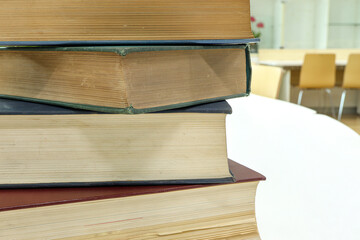 A stack of old books on table in library.Conceptual background on library, education