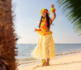 Hula Hawaii dancer dancing on sea beach at sunset