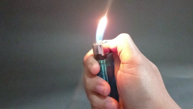 hand lighting a match in black background