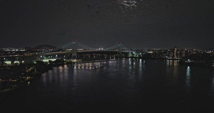 NYC New York Aerial v275 drone flyover East river towards RFK bridge capturing illuminated crossing, connecting Astoria Queens and Randalls Island at night - Shot with Inspire 3 8k - September 2023