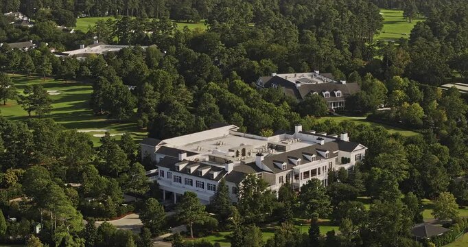 Augusta Georgia Aerial v50 zoomed birds eye view flyover National Golf Course capturing private clubhouse and cabins, lush fairways and cityscape views - Shot with Mavic 3 Pro Cine - October 2023