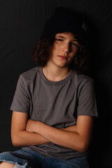 teenage boy with black nails and torn jeans