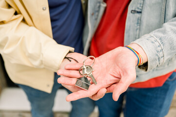 happy Couple With Keys Standing Outside New Home
