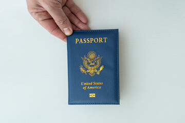 hand holding U.S. passport. issuance of American passport, obtaining US citizenship